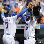 New York Mets' Tomas Nido (3) celebrates with teammate Asdrubal Cabrera (13) after they scored on a home run by Cabrera during the seventh inning of a baseball game against the Arizona Diamondbacks, Sunday, May 20, 2018, in New York. (AP Photo/Frank Franklin II)