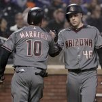 Arizona Diamondbacks' Deven Marrero (10) is congratulated by Patrick Corbin (46) after scoring against the New York Mets during the second inning of a baseball game, Saturday, May 19, 2018, in New York. (AP Photo/Julie Jacobson)