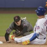 Arizona Diamondbacks shortstop Nick Ahmed, left, dives to tag out New York Mets' Asdrubal Cabrera, right, who was trying to advance to second base on a single to right field during the first inning of a baseball game, Saturday, May 19, 2018, in New York. (AP Photo/Julie Jacobson)