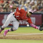 Washington Nationals third baseman Wilmer Difo (1) dives for a ball thrown by catcher Pedro Severino in the sixth inning during a baseball game against the Arizona Diamondbacks, Sunday, May 13, 2018, in Phoenix. (AP Photo/Rick Scuteri)