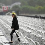 A racing fan walks in the seating area ahead of the 143rd Preakness Stakes horse race at Pimlico race course, Saturday, May 19, 2018, in Baltimore. (AP Photo/Nick Wass)
