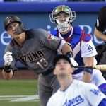 Arizona Diamondbacks' Nick Ahmed, left, runs to first on an inside-the-park home run off Los Angeles Dodgers starting pitcher Alex Wood, front, during the first inning of a baseball game Wednesday, May 9, 2018, in Los Angeles. (AP Photo/Mark J. Terrill)