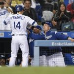 Los Angeles Dodgers' Enrique Hernandez celebrates with manager Dave Roberts, center, and Bob Geren after hitting the game-tying solo home run during the ninth inning of a baseball game against the Arizona Diamondbacks in Los Angeles, Tuesday, May 8, 2018. (AP Photo/Kelvin Kuo)