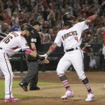 Arizona Diamondbacks center fielder Chris Owings (16) and Arizona Diamondbacks shortstop Ketel Marte (4) celebrate after scoring runs on a single hit by Jarrod Dyson in the seventh inning during a baseball game against the Washington Nationals, Sunday, May 13, 2018, in Phoenix. (AP Photo/Rick Scuteri)