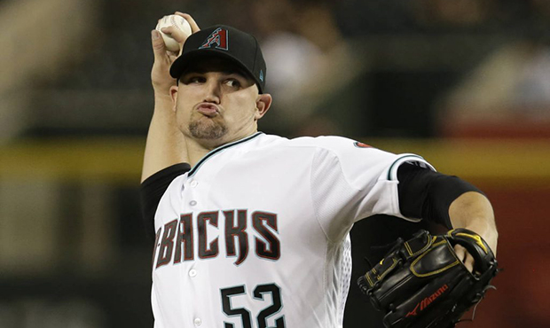 Arizona Diamondbacks pitcher Zack Godley throws during the first inning of the team's baseball game...