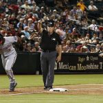 Washington Nationals' Michael Taylor (3) runs home as umpire Marty Foster, middle, signals to the runner to go after calling a balk on Arizona Diamondbacks pitcher Archie Bradley, as Diamondbacks third baseman Daniel Descalso, right, looks on during the eighth inning of a baseball game Thursday, May 10, 2018, in Phoenix. (AP Photo/Ross D. Franklin)