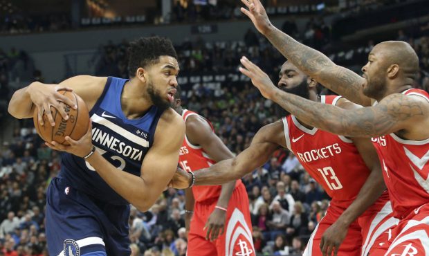 Minnesota Timberwolves' Karl-Anthony Towns, left, is double-teamed by Houston Rockets' PJ Tucker, r...
