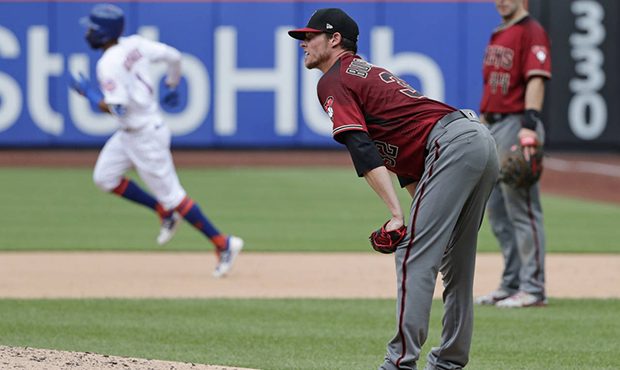 Arizona Diamondbacks starting pitcher Clay Buchholz reacts as New York Mets' Amed Rosario runs the ...