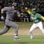 Oakland Athletics relief pitcher Santiago Casilla, right, throws out Arizona Diamondbacks' David Peralta, left, at first base after a ground ball during the eighth inning of a baseball game Friday, May 25, 2018, in Oakland, Calif. (AP Photo/Marcio Jose Sanchez)