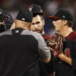 Arizona Diamondbacks starting pitcher Troy Scribner, right, gets an early visit from pitching coach Mike Butcher, middle, catcher John Ryan Murphy, left, and first baseman Paul Goldschmidt, second from right, during the first inning of a baseball game against the Washington Nationals Saturday, May 12, 2018, in Phoenix. (AP Photo/Ross D. Franklin)