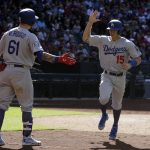 Los Angeles Dodgers' Austin Barnes (15) celebrates with Alex Verdugo (61) after scoring on a hit by Kyle Farmer during the eighth inning of a baseball game against the Arizona Diamondbacks, Thursday, May 3, 2018, in Phoenix. (AP Photo/Rick Scuteri)