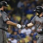 Arizona Diamondbacks' Chris Owings, right, celebrates with Paul Goldschmidt after hitting a solo home run during the third inning of a baseball game against the Los Angeles Dodgers in Los Angeles, Tuesday, May 8, 2018. (AP Photo/Kelvin Kuo)