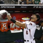 Arizona Diamondbacks' David Peralta tosses two cups of water in the air during a pre-game ritual prior to a baseball game against the Milwaukee Brewers Wednesday, May 16, 2018, in Phoenix. (AP Photo/Ross D. Franklin)
