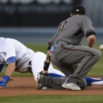 Arizona Diamondbacks shortstop Nick Ahmed, right, is unable to handle a throw as Los Angeles Dodgers' Chris Taylor steals second base during the first inning of a baseball game in Los Angeles, Tuesday, May 8, 2018. (AP Photo/Kelvin Kuo)