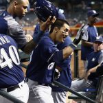 Milwaukee Brewers' Tyler Saladino, middle, celebrates his home run against the Arizona Diamondbacks with coach Jason Lane (40), Orlando Arcia, top left, Jonathan Villar, right, and other coaches and teammates during the fourth inning of a baseball game Wednesday, May 16, 2018, in Phoenix. (AP Photo/Ross D. Franklin)