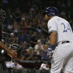 Milwaukee Brewers' Jesus Aguilar (24) looks back at umpire Alan Porter (64) after being called out on strikes during the ninth inning of the team's baseball game against the Arizona Diamondbacks Tuesday, May 15, 2018, in Phoenix. The Diamondbacks defeated the Brewers 2-1. (AP Photo/Ross D. Franklin)