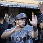 Arizona Diamondbacks' Jeff Mathis is congratulated in the dugout after scoring on a triple by Paul Goldschmidt during the fourth inning of a baseball game against the Oakland Athletics on Friday, May 25, 2018, in Oakland, Calif. (AP Photo/Marcio Jose Sanchez)