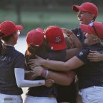 Arizona players mob Haley Moore, center, after Arizona defeated Alabama during the final round of the NCAA Division I women's golf championship in Stillwater, Okla., Wednesday, May 23, 2018. (AP Photo/Sue Ogrocki)