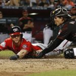 Washington Nationals' Trea Turner, left, gets tagged out at home plate by Arizona Diamondbacks catcher John Ryan Murphy, right, during the sixth inning of a baseball game Saturday, May 12, 2018, in Phoenix. (AP Photo/Ross D. Franklin)