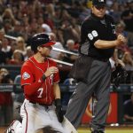 Washington Nationals' Trea Turner (7) kneels at home plate after being tagged out against the Arizona Diamondbacks as umpire Doug Eddings (88) calls the runner out during the sixth inning of a baseball game Saturday, May 12, 2018, in Phoenix. (AP Photo/Ross D. Franklin)
