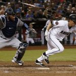 Arizona Diamondbacks' Zack Greinke, right, runs to first base on a sacrifice bunt as Milwaukee Brewers catcher Manny Pina, left, runs for the ball during the fifth inning of a baseball game Tuesday, May 15, 2018, in Phoenix. (AP Photo/Ross D. Franklin)