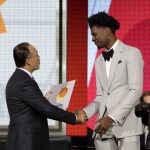 NBA Deputy Commissioner Mark Tatum, left, congratulates Phoenix Suns forward Josh Jackson after Tatum announced that the Suns had won the first pick of the NBA basketball draft, during the draft lottery Tuesday, May 15, 2018, in Chicago. (AP Photo/Charles Rex Arbogast)