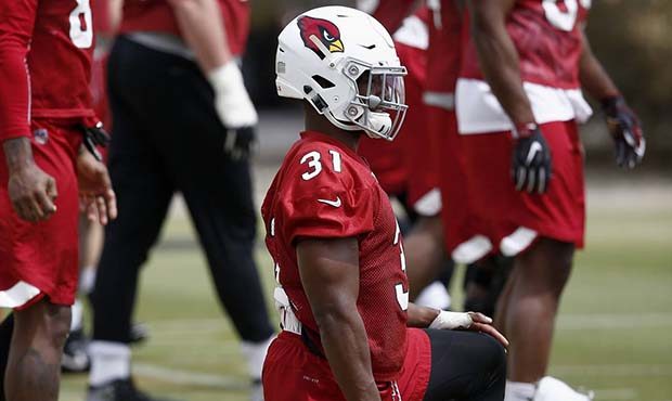 Arizona Cardinals running back David Johnson (31) stretches out with teammates during a voluntary t...