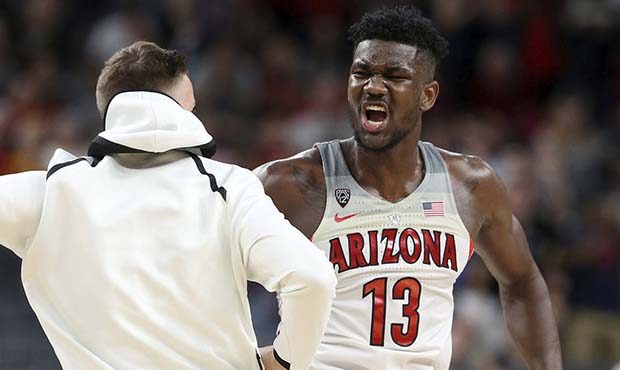 Arizona's Deandre Ayton, right, celebrates an overtime win with a teammate following the team's NCA...