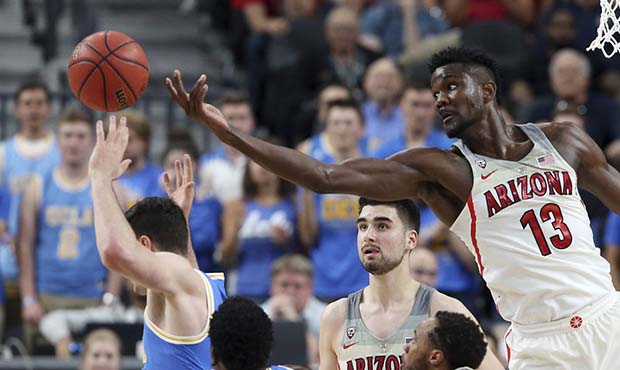 Arizona's Deandre Ayton (13) reaches for a rebound during the second half of the team's NCAA colleg...
