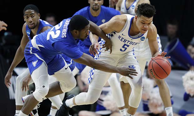 Kentucky forward Kevin Knox (5) and Buffalo guard Dontay Caruthers (22) reach for a loose ball duri...