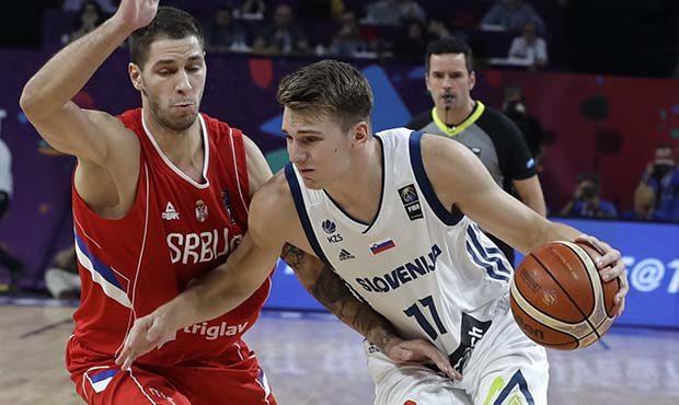 Serbia's Stefan Jovic, left, challenges Slovenia's Luka Doncic, right, during their Eurobasket Euro...