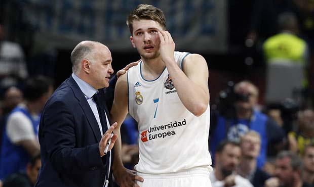 Real Madrid head coach Pablo Laso gives instructions to Real Madrid's Luka Doncic during their Fina...
