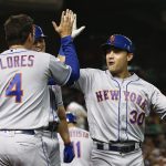 New York Mets' Michael Conforto (30) celebrates his three-run home run against the Arizona Diamondbacks with Wilmer Flores (4) and Brandon Nimmo, back left, during the second inning of a baseball game Saturday, June 16, 2018, in Phoenix. (AP Photo/Ross D. Franklin)