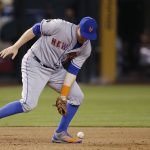 New York Mets third baseman Todd Frazier is unable to come up with a grounder hit by Arizona Diamondbacks' John Ryan Murphy during the eighth inning of a baseball game Saturday, June 16, 2018, in Phoenix. Frazier was charged with an error. The Mets defeated the Diamondbacks 5-1. (AP Photo/Ross D. Franklin)