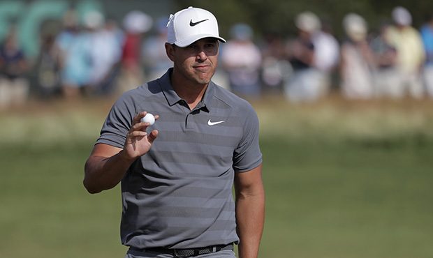 Brooks Koepka reacts after putting on the 12th green during the final round of the U.S. Open Golf C...