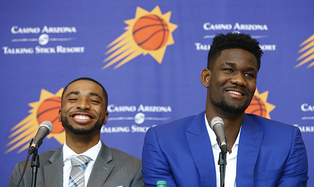 Phoenix Suns' Mikal Bridges, left, and Deandre Ayton, right, laugh as they answer a question as the...