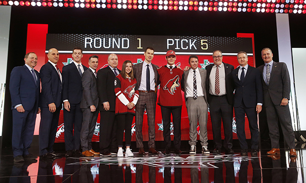 Barrett Hayton, fifth from right, of Canada, poses after being selected by the Phoenix Coyotes duri...