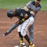 Pittsburgh Pirates' Elias Diaz, left, pushes into Arizona Diamondbacks second baseman Daniel Descalso after being forced out on a ground ball by Jordy Mercer during the sixth inning of a baseball game, Saturday, June 23, 2018, in Pittsburgh. (AP Photo/Keith Srakocic)