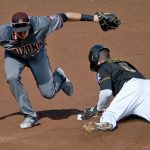 Pittsburgh Pirates' Starling Marte (6) steals the base as Arizona Diamondbacks shortstop Nick Ahmed applies a late tag in the first inning of a baseball game, Saturday, June 23, 2018, in Pittsburgh. (AP Photo/Keith Srakocic)