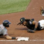 Pittsburgh Pirates first baseman Josh Bell, right, looks for the call after diving to tag Arizona Diamondbacks' David Peralta (6) in the ninth inning of a baseball game, Saturday, June 23, 2018, in Pittsburgh. Peralta was initially called safe but the play was overturned on review. (AP Photo/Keith Srakocic)