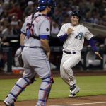 Arizona Diamondbacks' John Ryan Murphy, right, scores on a base hit by Ketel Marte during the second inning of a baseball game Thursday, June 14, 2018, in Phoenix as New York Mets catcher Devin Mesoraco waits for a possible throw. (AP Photo/Matt York)