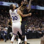 Cleveland Cavaliers' LeBron James is called for a charging foul against Golden State Warriors' Stephen Curry during the second half of Game 4 of basketball's NBA Finals, Friday, June 8, 2018, in Cleveland. (AP Photo/Tony Dejak)