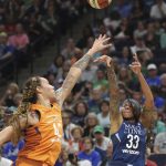 Minnesota Lynx's Seimone Augustus (33) hits a 3-point shot over the Phoenix Mercury's Brittney Griner (42) during the first half of a WNBA basketball game Friday, June 1, 2018, in Minneapolis. (David Joles/Star Tribune via AP)