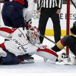 Washington Capitals goaltender Braden Holtby, left, gives up a goal to Vegas Golden Knights left wing David Perron, right, during the second period in Game 5 of the NHL hockey Stanley Cup Finals on Thursday, June 7, 2018, in Las Vegas. (AP Photo/John Locher)