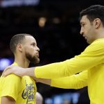 Golden State Warriors center Zaza Pachulia, right, talks with Stephen Curry during halftime in Game 4 against the Cleveland Cavaliers in basketball's NBA Finals, Friday, June 8, 2018, in Cleveland. (AP Photo/Tony Dejak)
