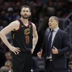 Cleveland Cavaliers coach Tyronn Lue talks with Kevin Love during the second half in Game 4 against the Golden State Warriors in basketball's NBA Finals, Friday, June 8, 2018, in Cleveland. (AP Photo/Tony Dejak)