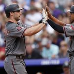 Arizona Diamondbacks' Paul Goldschmidt, left, is congratulated by Jon Jay after Goldschmidt hit a three-run home run off Colorado Rockies starting pitcher Chad Bettis during the fourth inning of a baseball game Saturday, June 9, 2018, in Denver. (AP Photo/David Zalubowski)
