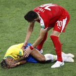 Brazil's Neymar is attended to by Serbia's Dusan Tadic during the group E match between Serbia and Brazil, at the 2018 soccer World Cup in the Spartak Stadium in Moscow, Russia, Wednesday, June 27, 2018. (AP Photo/Antonio Calanni)