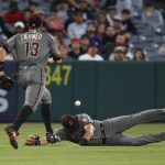 Arizona Diamondbacks' David Peralta, right, misses a double hit by Los Angeles Angels' Ian Kinsler as Nick Ahmed runs to cover for Peralta during the third inning of a baseball game, Monday, June 18, 2018, in Anaheim, Calif. (AP Photo/Jae C. Hong)