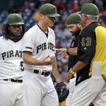 Pittsburgh Pirates starting pitcher Chad Kuhl, center, hands the ball to manager Clint Hurdle (13) after giving up a two-run home run to Arizona Diamondbacks' Alex Avila during the third inning of a baseball game in Pittsburgh, Thursday, June 21, 2018. (AP Photo/Gene J. Puskar)